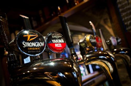 a row of parked motorcycles with stickers on them at Norfolk Arms Hotel, Ringinglow in Sheffield