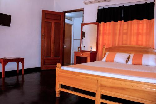 En eller flere senge i et værelse på D'Villa Guest House