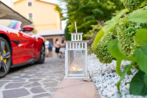 a lantern on the side of a street with a car at BBSUITE21 Maranello in Maranello