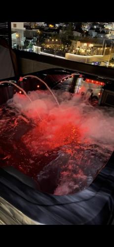 a hot tub filled with red liquid with a fountain at Hotel Joni Premium in Ksamil