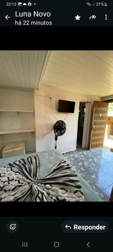 a picture of a room with a bed and a phone at Pousada Margareth in Ilha do Mel