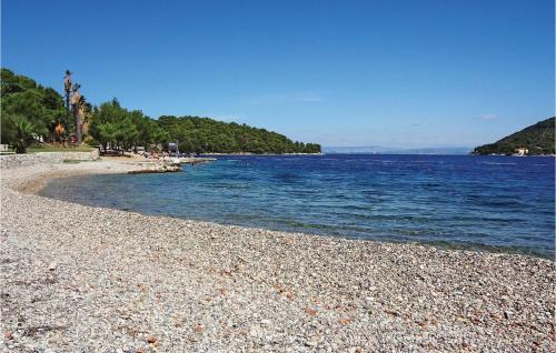 a beach with a rocky shore and the water at Gorgeous Home In Vis With Sauna in Vis