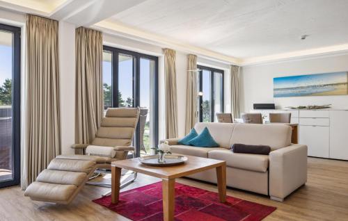 a living room with a couch and a table at Cloud in Binz