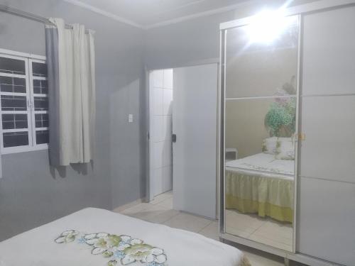 a bedroom with a glass partition with a bed in it at Apto 10 preço acessível in Brasília