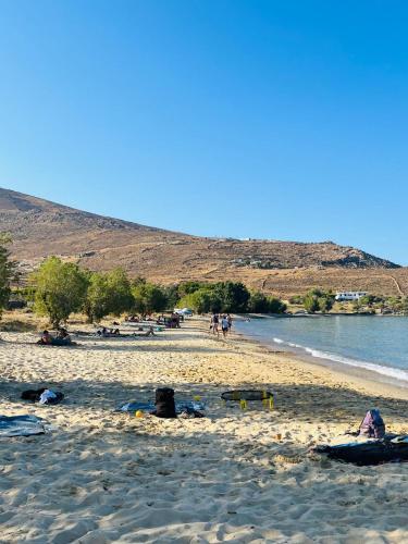 a group of people on a beach near the water at Infinity View Villa Agios Ioannis Serifos in Serifos Chora