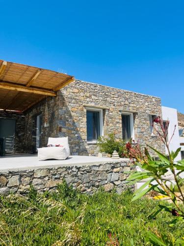 a stone house with a stone wall at Infinity View Villa Agios Ioannis Serifos in Serifos Chora