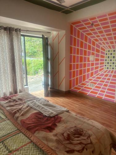 a bedroom with a bed in a room with a window at Magic View Guest House in Kasauli