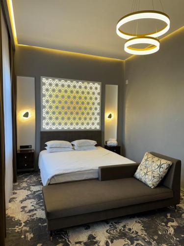 a bedroom with a bed and a large window at Jasmine in Taraz