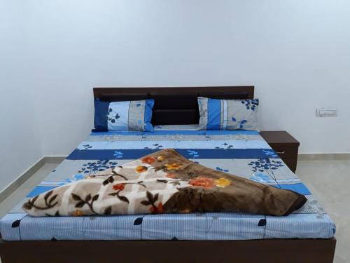 um quarto com uma cama com edredão azul em Gir Enjoy Forest Resort em Sasan Gir
