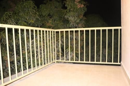 a fence on a porch at night at Gir Enjoy Forest Resort in Sasan Gir