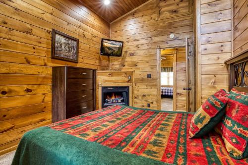a bedroom with a bed and a fireplace at Mountain Charm- Hot Tub, Game Room, Theater Room, free Attraction Tickets!!! in Sevierville