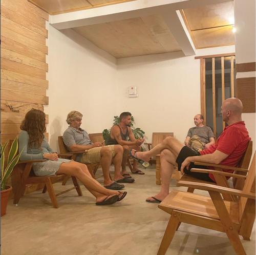 a group of people sitting in chairs in a room at Suffix Retreat - Stay, Dive & Explore Fuvahmulah in Fuvahmulah