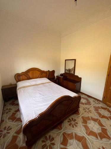 a bedroom with a large bed and a dresser at Calm Coast Villa in Agaouz
