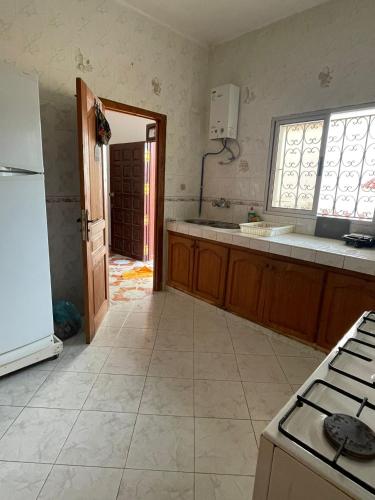 a kitchen with a refrigerator and a counter top at Calm Coast Villa in Agaouz