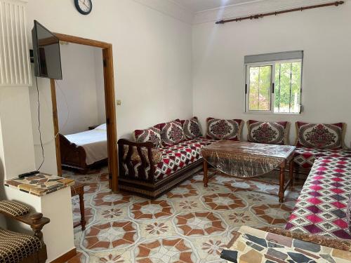 a living room with a couch and a table at Calm Coast Villa in Agaouz