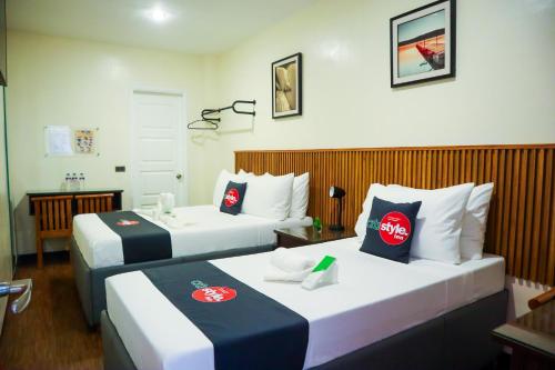 Postel nebo postele na pokoji v ubytování Citistyle Inn