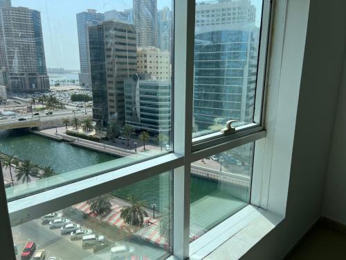 a view of a city from a window at Top Rated Award Winning 1BR with Sea View in Sharjah