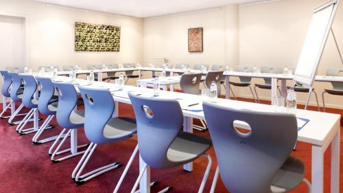 a conference room with a long table and chairs at Atlas Hotel Brussels in Brussels