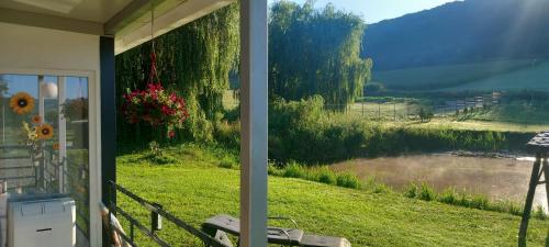 a view of a river from the porch of a house at Lacurile IRION in Hoghilag