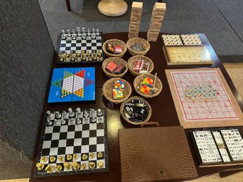 a table with chessboards and other games on it at Jjimjbang hotel spa in Manila