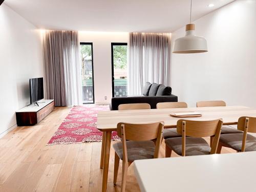 a white living room with a table and chairs at Modern, Charming, Spacious 3-Bedroom Retreat in Brooklyn with Rem-casa in Brooklyn