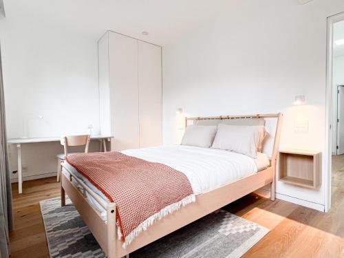 a bedroom with a large bed with white walls at Modern, Charming, Spacious 3-Bedroom Retreat in Brooklyn with Rem-casa in Brooklyn