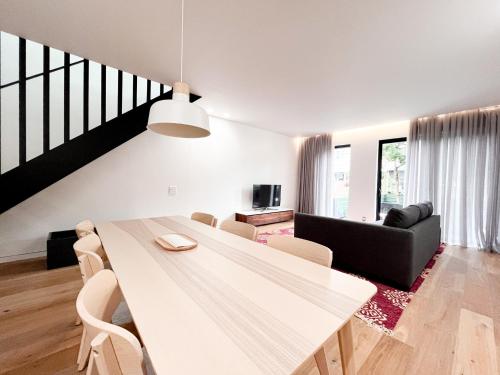 a dining room with a white table and chairs at Modern, Charming, Spacious 3-Bedroom Retreat in Brooklyn with Rem-casa in Brooklyn