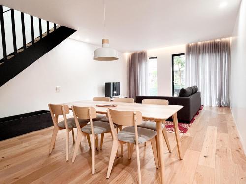 a dining room and living room with a table and chairs at Modern, Charming, Spacious 3-Bedroom Retreat in Brooklyn with Rem-casa in Brooklyn