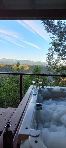 a jacuzzi tub with a person sitting in a chair at Forest Valley Cottages in Knysna