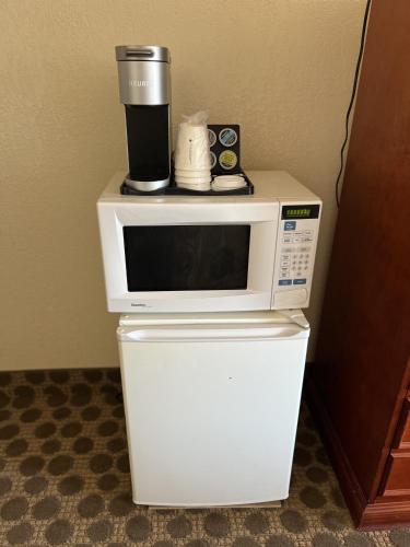 a coffee maker sitting on top of a microwave at Travelodge by Wyndham Drumheller AB in Drumheller