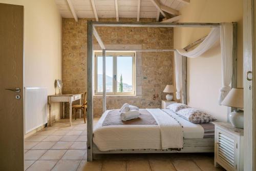 a bedroom with a bed in a room with a window at Riglia Villas in Riglia