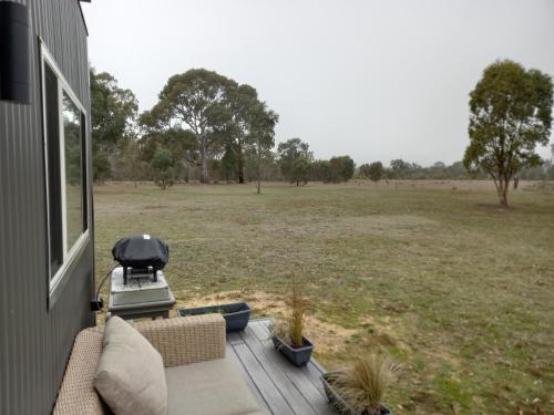 a view of a field from the porch of a house at Redman View Luxury Lakeside Cabin in Lake Fyans