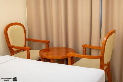 Postel nebo postele na pokoji v ubytování Al Jabal Hotel