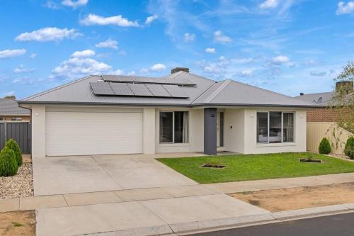 a house with solar panels on the roof at Popular Villa Shepparton in Shepparton