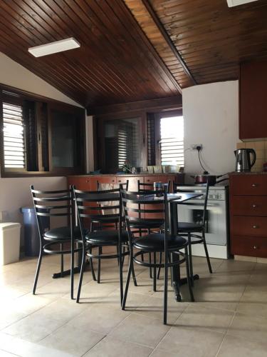 Una habitación con una mesa y sillas en una cocina. en Nefeli House, en Kato Platres