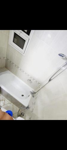 a bathroom with a toilet and a window on the ceiling at عجمان النعمية in Ajman 