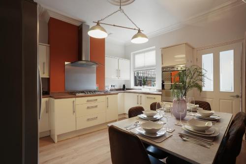 a kitchen with a table with chairs and a dining room at 3 bed city centre, FREE parking, Contractors, Long Stays in Doncaster