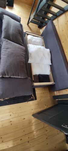 an overhead view of a bed with pillows on the floor at Naujai įrengtas atostogų namelis in Anykščiai