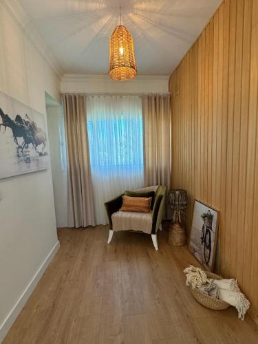 a living room with a couch and a chandelier at Casa del Olivia in Seferihisar