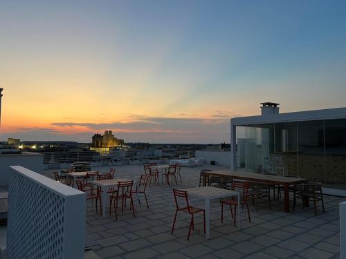 a group of tables and chairs on a roof at Canneddi Boutique Farm in Avetrana