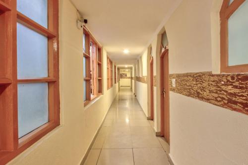 a corridor of an empty building with windows at Hotel Ibex in Manāli