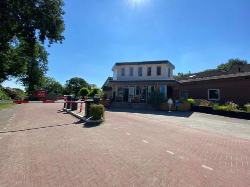 a brick parking lot in front of a building at Camping Heino in Heino