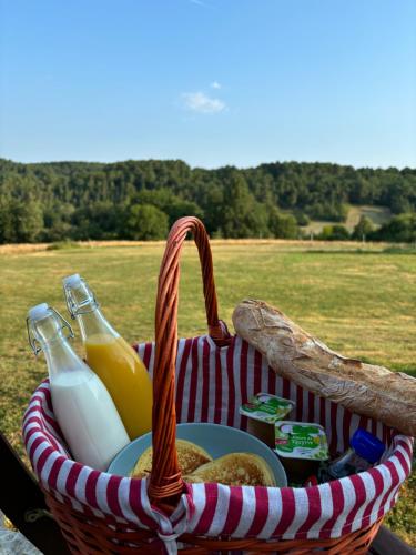 a picnic basket with bottles of milk and bread at Rooftop in Jaure