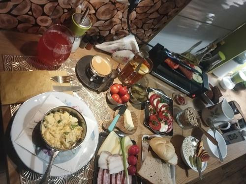 a table topped with plates of food on a table at Niewielki pokój dla jednej osoby lub pary. in Warsaw
