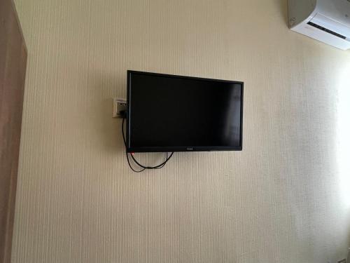 a flat screen tv hanging on a wall at Rahat Hotel in Ganja