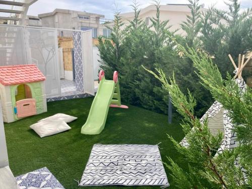 a backyard with a playground with a slide at Le case di Fiò in Sciacca