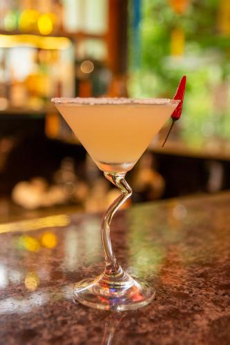 a martini glass sitting on top of a bar at Phong Nha Farmstay in Phong Nha