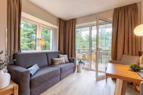 a living room with a couch and a table at Apart-Elisabeth in Mieming