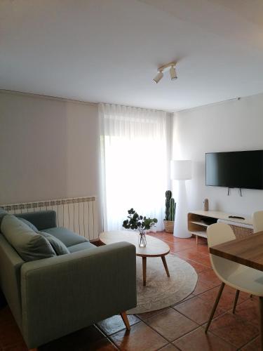 a living room with a couch and a tv at Casa Don Jaime in Magaña