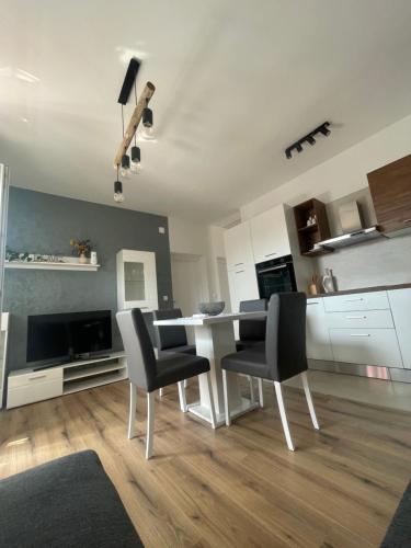 a kitchen with a dining room table and chairs at app Leka in Umag